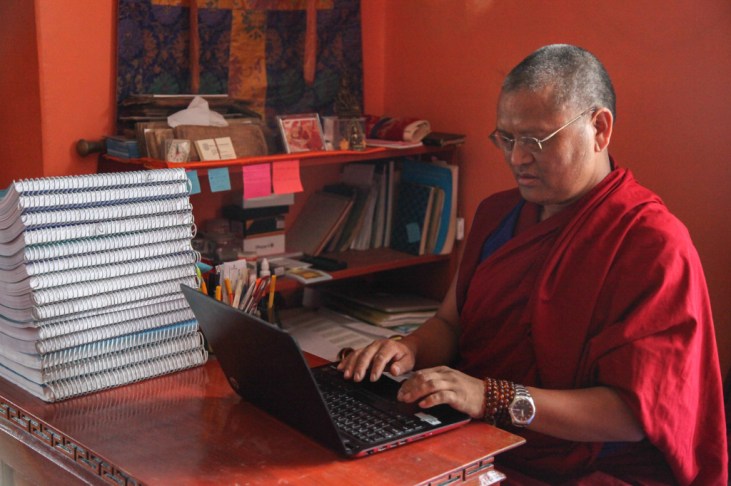Menri Lopon Rinpoche working at his laptop profile