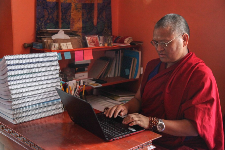 Menri Lopon Rinpoche working at his laptop profile
